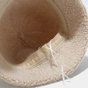 Interior detail of wool blend bucket hat with adjustable inner ribbon and beige lining