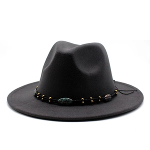 Detail of dark grey wool felt fedora featuring bohemian braided band with beads