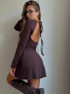 Detail of deep brown backless mini dress featuring elegant halter ties and ribbed texture