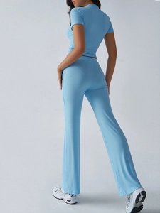 Rear view detail of blue short-sleeve knit top and high-waist straight pants set
