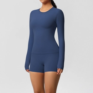 Detail of navy blue long sleeve yoga top and high waist shorts with matte finish