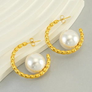 Vintage gold C-shaped earrings with large white pearl and textured beaded surface