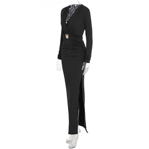 Detail of slim fit black maxi dress with deep V-neck, golden buckle, and side split