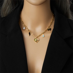 Rainbow heart and flower pendants on a gold titanium steel necklace worn by a model