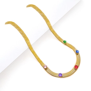 Golden snake bone necklace with colorful zircon stones on white background