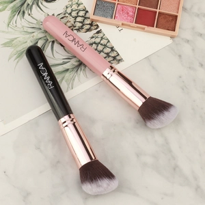 Detailed view of dual-color angled foundation brushes with soft bristles and metal ferrules