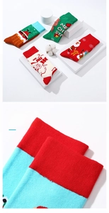 Detail of soft cotton Christmas crew socks featuring Santa and reindeer holiday patterns