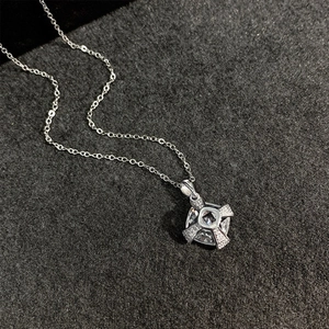 S925 sterling silver necklace with a brilliant cross star pendant on grey fabric