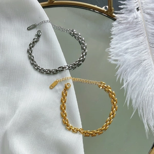 Minimalist 18K gold and silver plated link bracelets on elegant reflective background