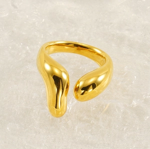 Detailed view of an 18K gold plated stainless steel ring with liquid metal design