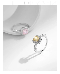 Macro view of S925 silver rings with square pink and yellow crystals and side diamond details