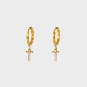 Macro shot of gold-plated T-letter earrings with shimmering cubic zirconia settings