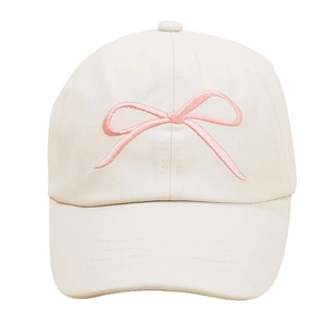 Detailed frontal view of white children baseball cap with pink embroidered bow
