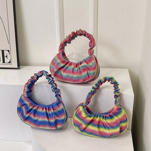 Three gradient hobo bags with pleated handles displayed on a white minimalist stage
