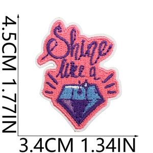 Macro shot of pink diamond embroidery patch with height and width size measurements