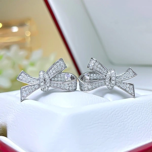 Elegant silver bow earrings with zircon micro-pave in a white leather jewelry box