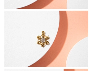 Detailed macro shot of a golden snowflake pendant with clear rhinestones for jewelry DIY