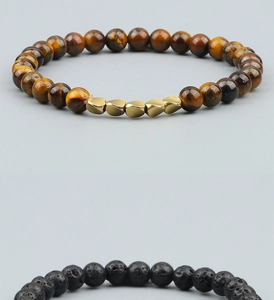 Macro detail of tiger eye beads with golden metallic accents and black lava rock beads