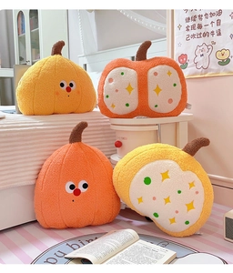 Detail showing various plush pumpkin pillows in vibrant orange and yellow with cute faces