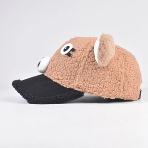 Side profile detail of kids soft plush puppy baseball cap with 3D ears and cartoon eyes