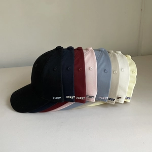 Group of colorful cotton baseball caps with side embroidery shown in various stylish colors