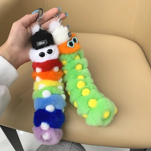 Detailed view of colorful plush caterpillar keychains with knit hats and sunglasses