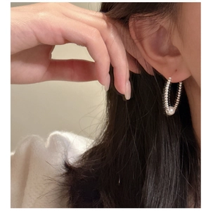Close-up of minimalist S925 sterling silver beaded hoop earrings with white pearls