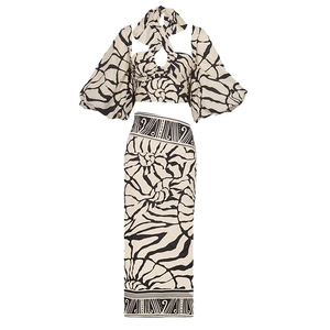 Detail of puffed sleeves and swirl print on a matching two-piece beach skirt set