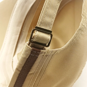Khaki cotton military cap with adjustable leather strap and bronze metal buckle details