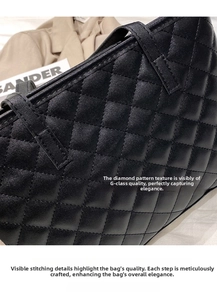 Close-up of black quilted leather tote bag showing detailed stitching and matte texture