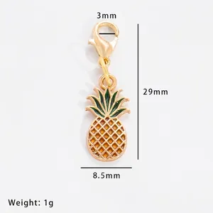 Detail of yellow pineapple alloy pendant with size markings and green leaves detail