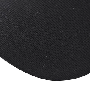 Close-up of black cotton twill fabric showing detailed weave and parallel stitching on a cap