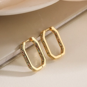 Chic gold-plated geometric hoop earrings with colorful zircon stones on white book