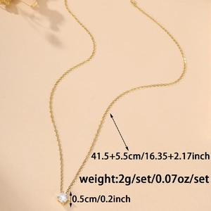 Detail of gold clavicle chain with 0.5cm round claw-set cubic zirconia pendant