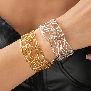 Detail view of 18K gold and silver plated crossover layered open cuff bracelets