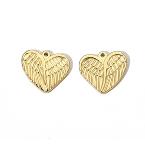 Macro detail of gold stainless steel heart charms with engraved wing texture
