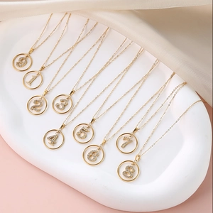 Gold stainless steel necklaces with zircon-studded Arabic numbers on silk backdrop
