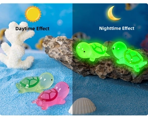 Luminous resin turtle decor shown in day and night lighting contrast with sea scene
