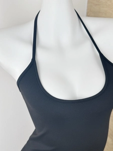 Close-up of black halter neck top with stretch knit texture on white mannequin