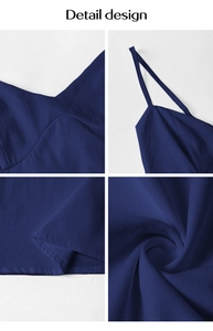 Detail view of blue elegant dress featuring V-neckline, spaghetti strap and pleated fabric