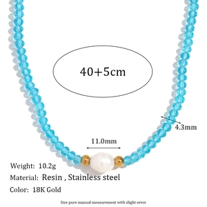 Blue crystal beads and freshwater pearl necklace with stainless steel beads on white background