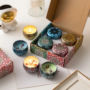 Four-piece soy wax scented candle set in colorful mandala metal tins with floral gift box