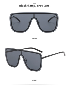 Front and 45-degree side views of black oversized flat top shield sunglasses with gray lenses