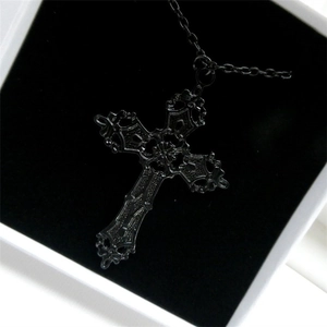 Gothic black cross necklace with ornate pendant detail on premium black jewelry box cushion