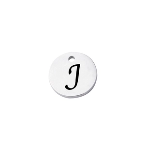 Close-up of a polished stainless steel round pendant with laser engraved letter J