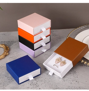 Stack of colorful drawer jewelry boxes with silk pull tabs for rings and earrings
