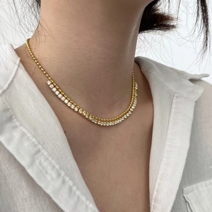 Golden olive leaf tassel necklace with white rhinestones on female neck collar