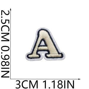Detail view of mini embroidered letter A patch with cream base and navy trim