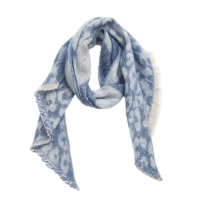 Detail shot of the blue and white checkered scarf featuring soft tassel edges and texture