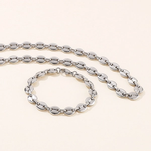 Detailed set of silver stainless steel coffee bean link necklace and bracelet ensemble